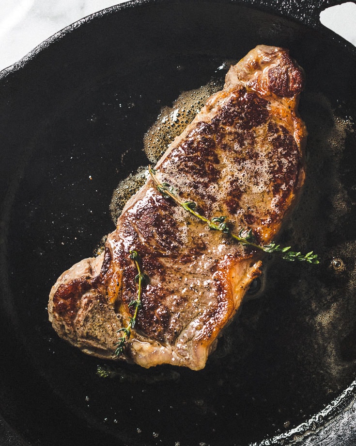 searing sous vide steak in skillet