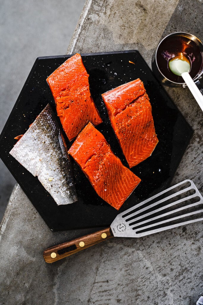 seasoned salmon filets on cutting board for grill