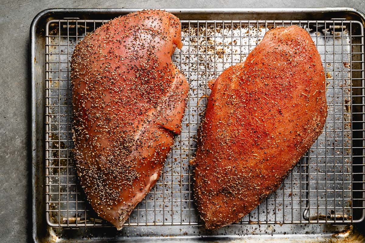 seasoned turkey breasts on sheet pan