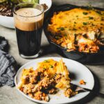 shepherds pie on plate and skillet with a beer vertical 2