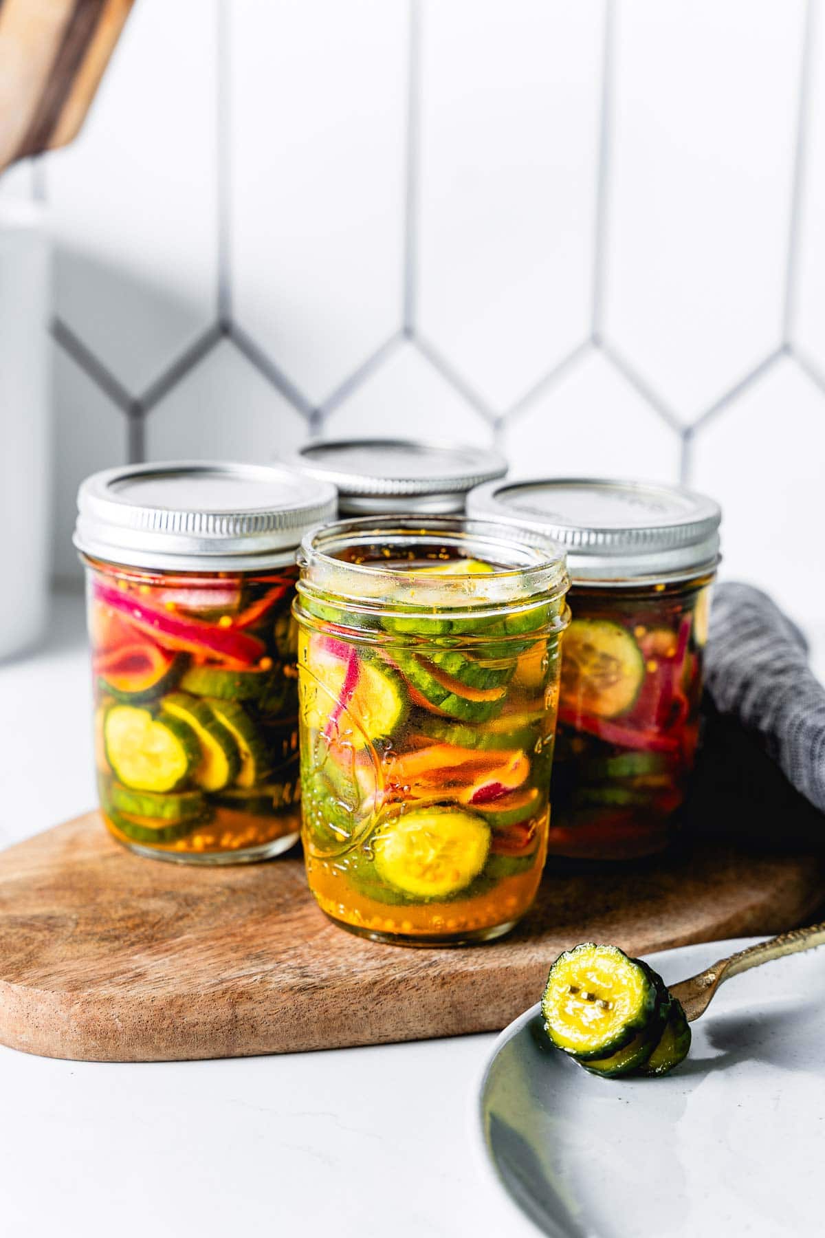 side view of bread and butter pickles in jars vertical
