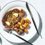 skillet rib eye steak. and potatoes horizontal
