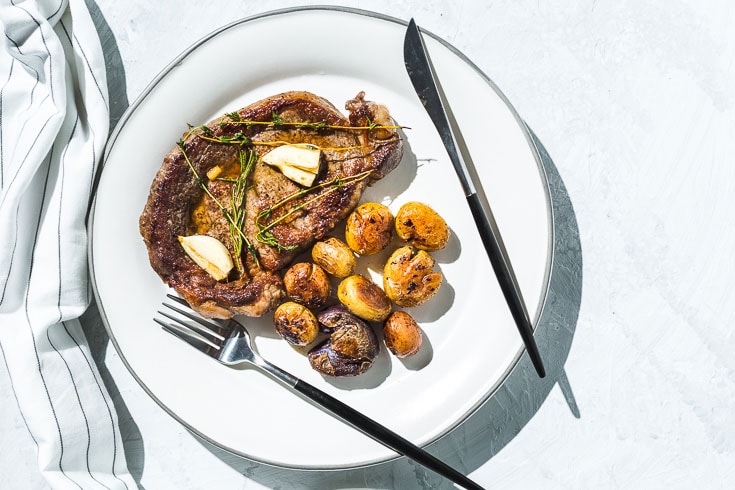 skillet rib eye steak. and potatoes horizontal