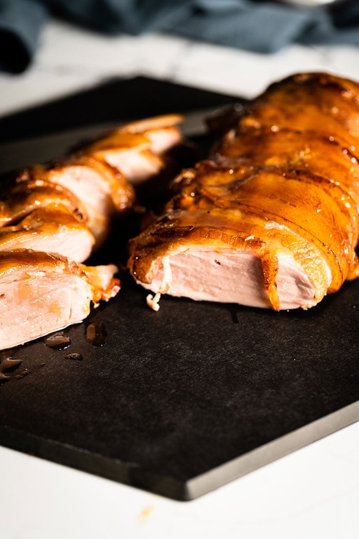 sliced bacon wrapped glazed smoked pork tenderloin vertical