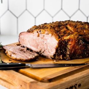 sliced roast pork shoulder on cutting board