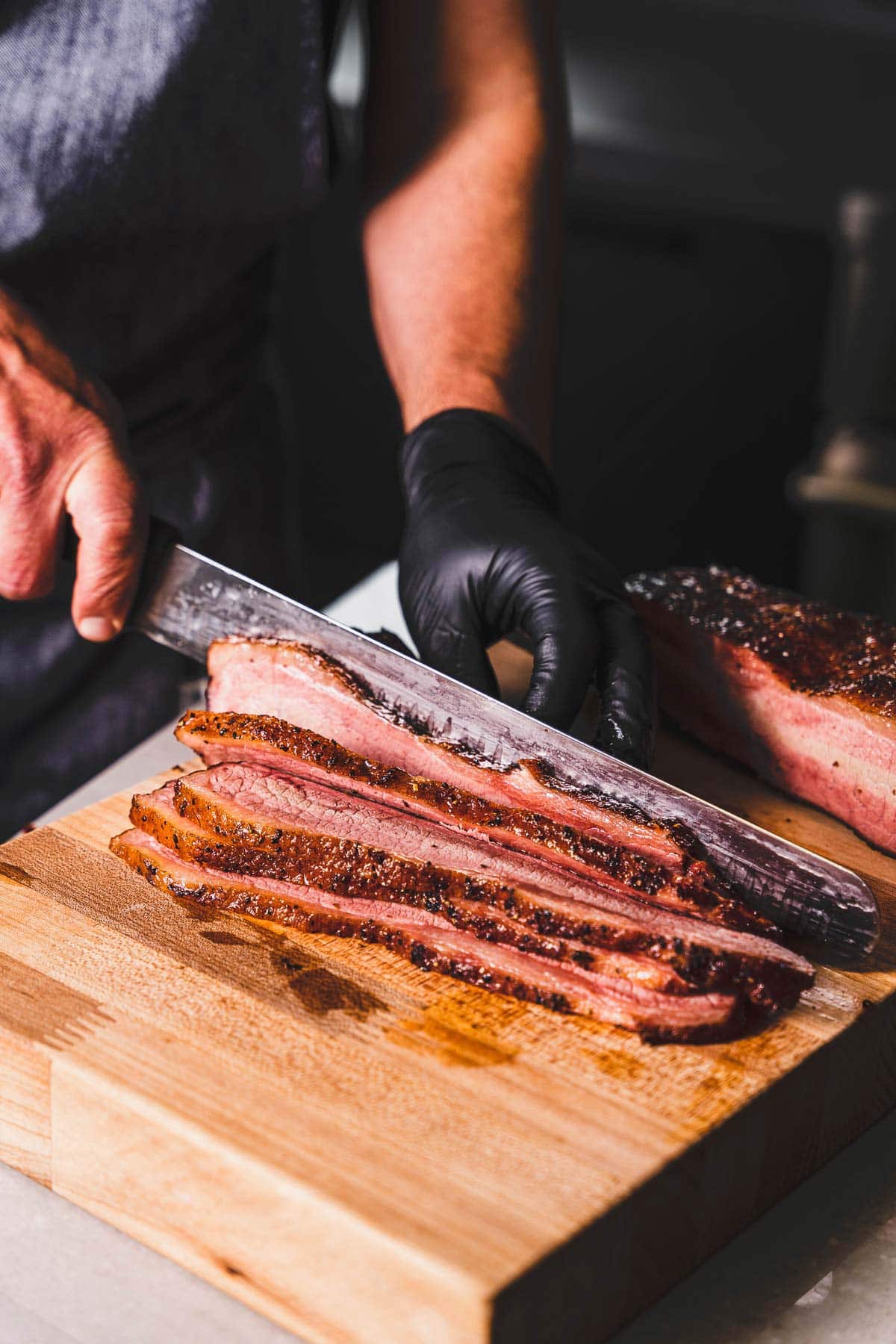 slicing a brisket flat with brisket slicing knife