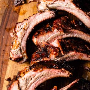 smoked baby back ribs on cutting board close up