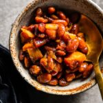 smoked baked beans in bowl with spoon