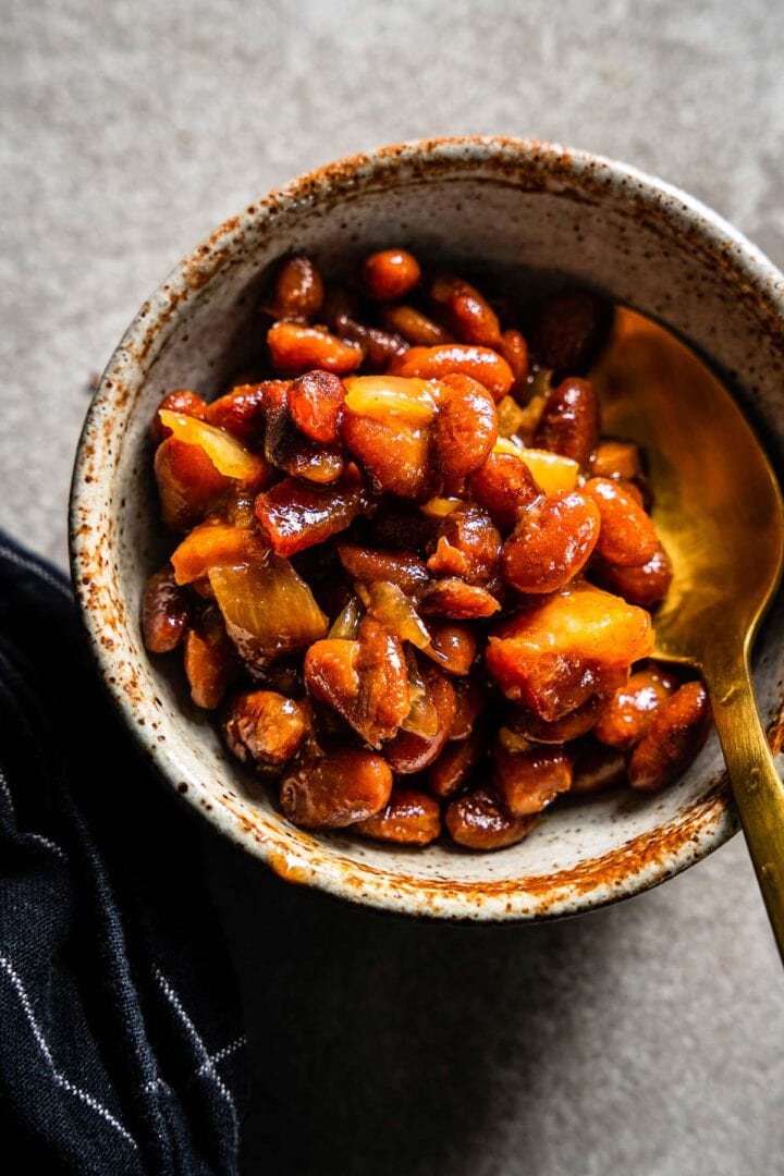 smoked baked beans in bowl with spoon