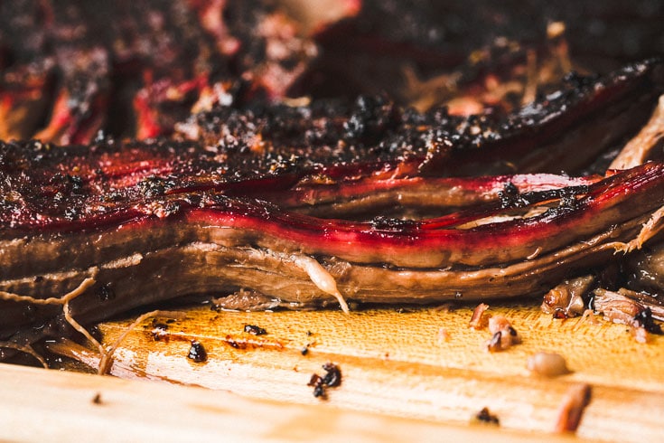 Close up of smoked brisket point sliced on cutting board