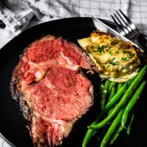 smoked prime rib sliced on plate featured