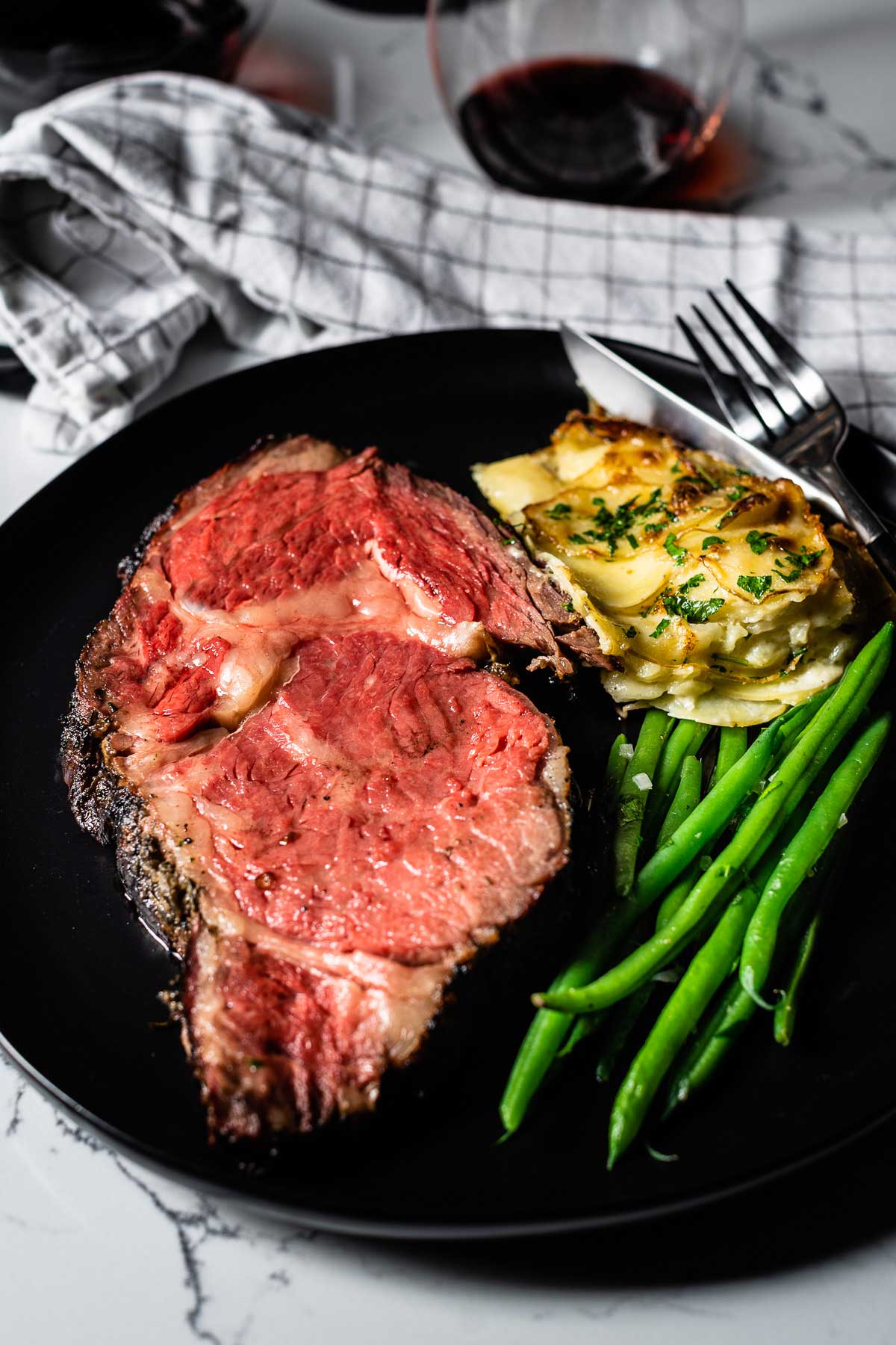 smoked prime rib sliced on plate featured