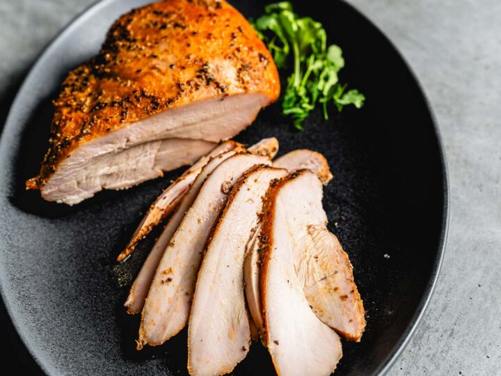 smoked turkey breast sliced on a serving platter horizontal