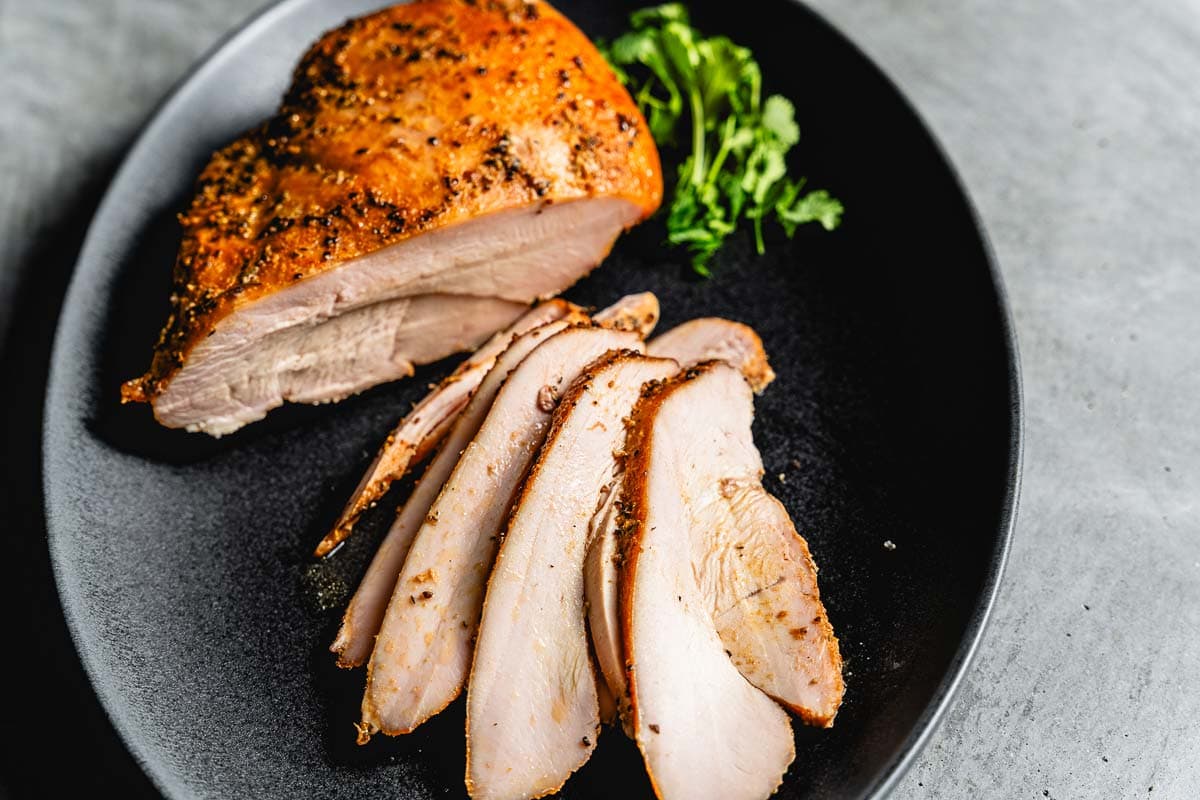 smoked turkey breast sliced on a serving platter horizontal