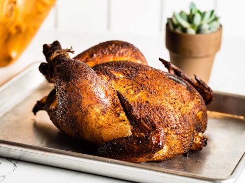 https://saltpepperskillet.com/wp-content/uploads/smoked-whole-chicken-horizontal-head-on-500x375.jpg