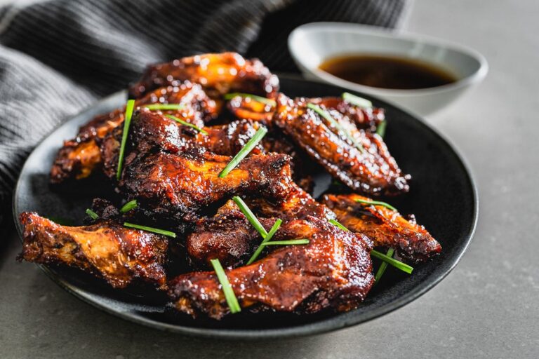smoky maple bourbon chicken wings on plate vertical