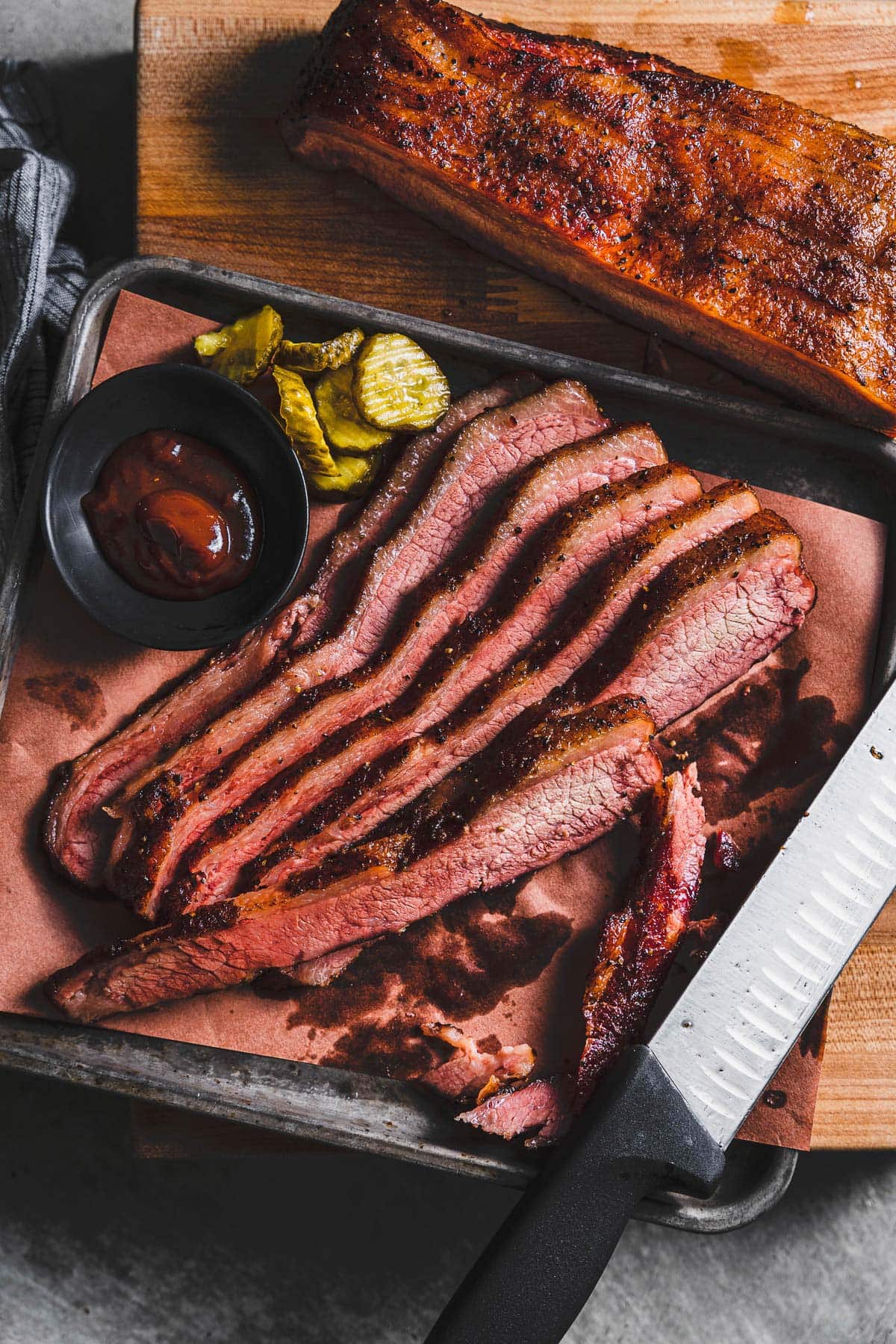 sous vide smoked brisket sliced on sheet pan vertical 1