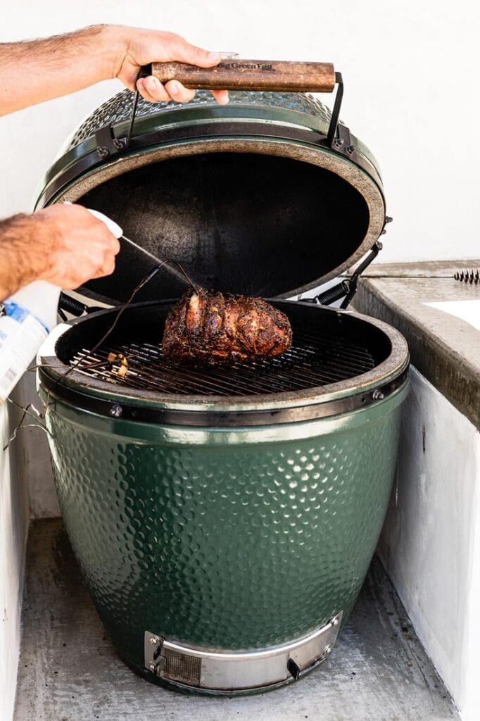 spritzing lamb shoulder in big green egg