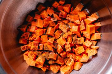 sweet potatoes and ingredients in bowl for roasting
