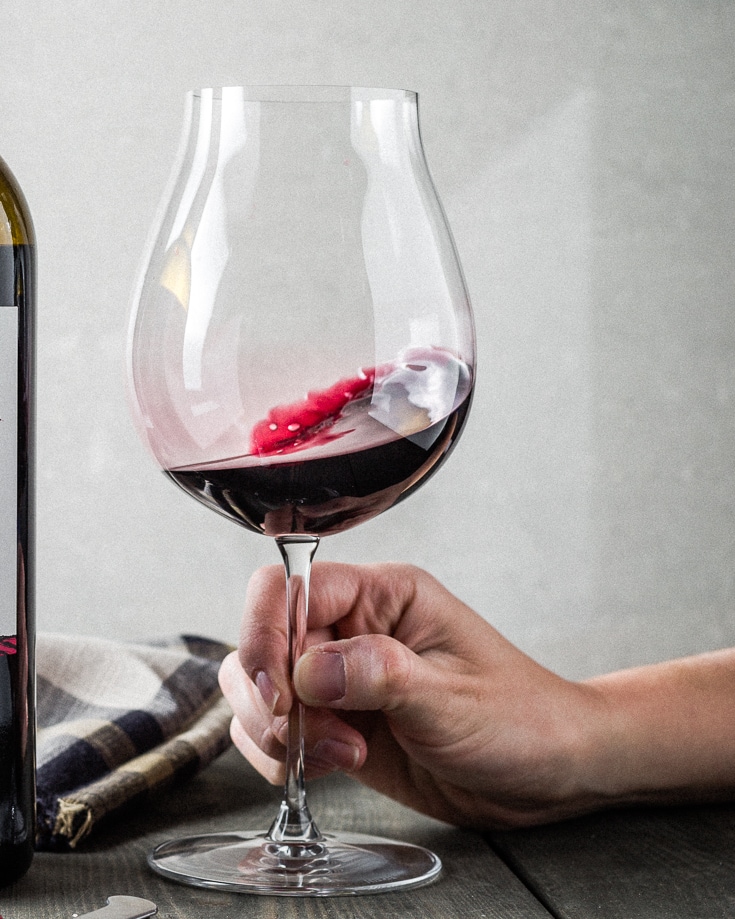 swirling red wine in glass