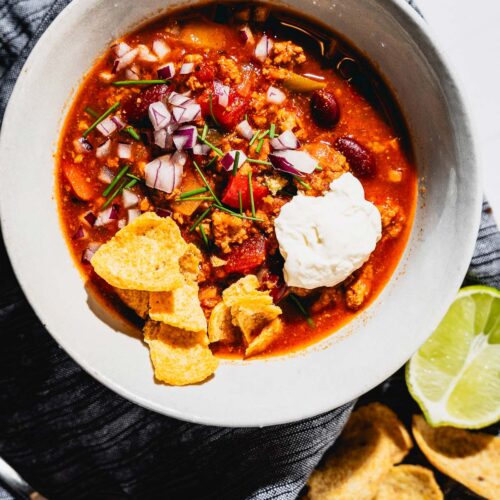 turkey chili with toppings in bowl overhead