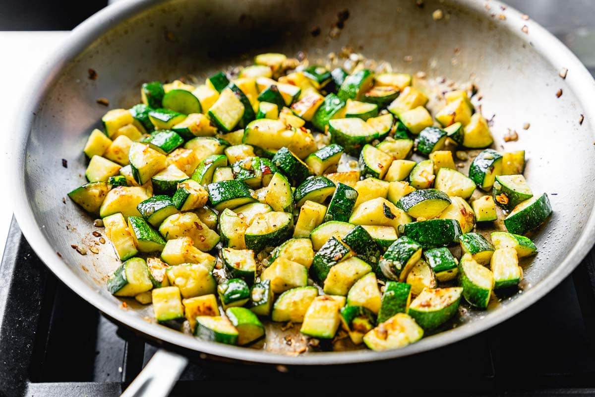 zucchini cooking in skillet horizontal